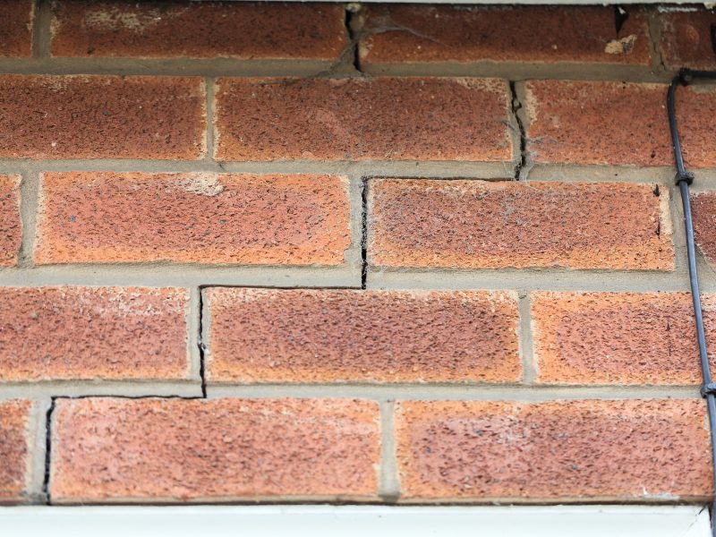 Cracked brick wall showing structural damage and the need for house subsidence solutions to prevent further movement.