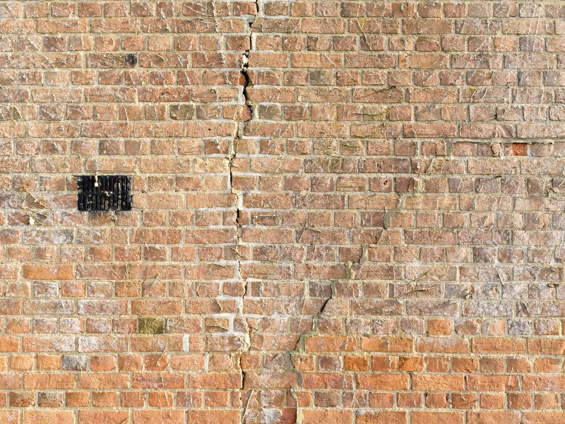 Large vertical crack across exterior brick wall requiring inspection and house subsidence solutions to stabilise the structure.